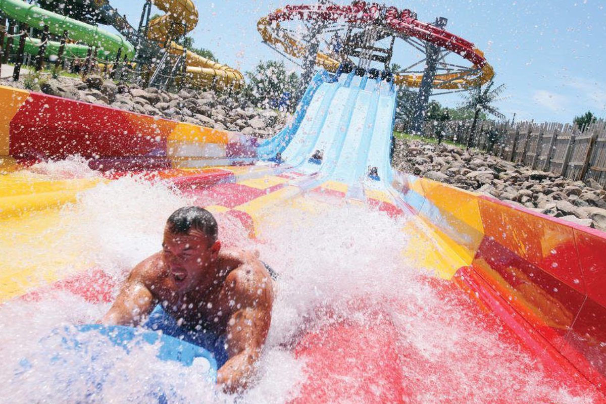 Image Showing A Man Enjoying in a water slide - Cedarfalls Waterloo.