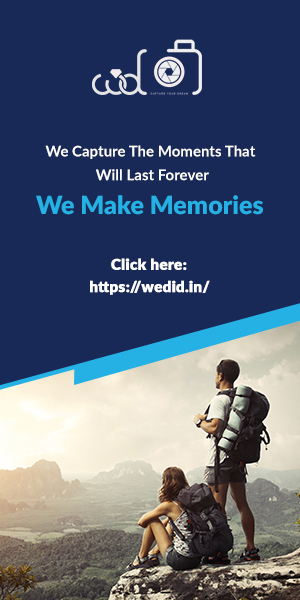 Two Young Adventure Travelers Capturing The High Elevations Of A Mountain Range With Cloudy Sky, Capturing Their Memories.