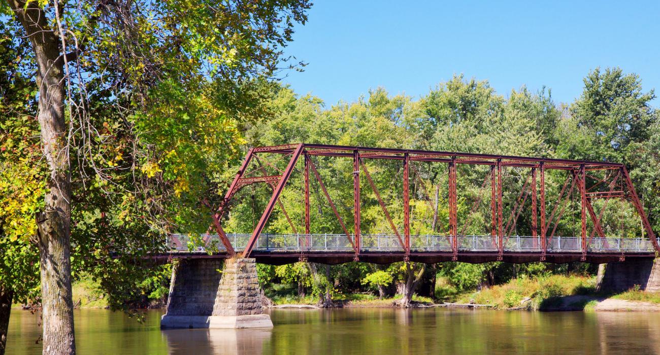 Image of Antiqur Bridge that hides among the group of trees.